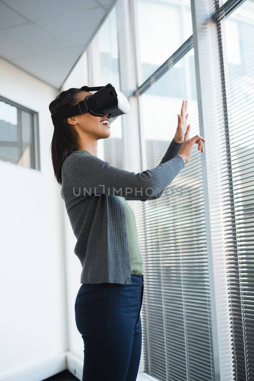 Female executive using virtual reality headset in office
