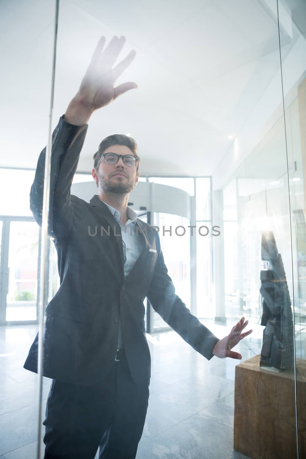 Businessman touching invisible digital screen in office