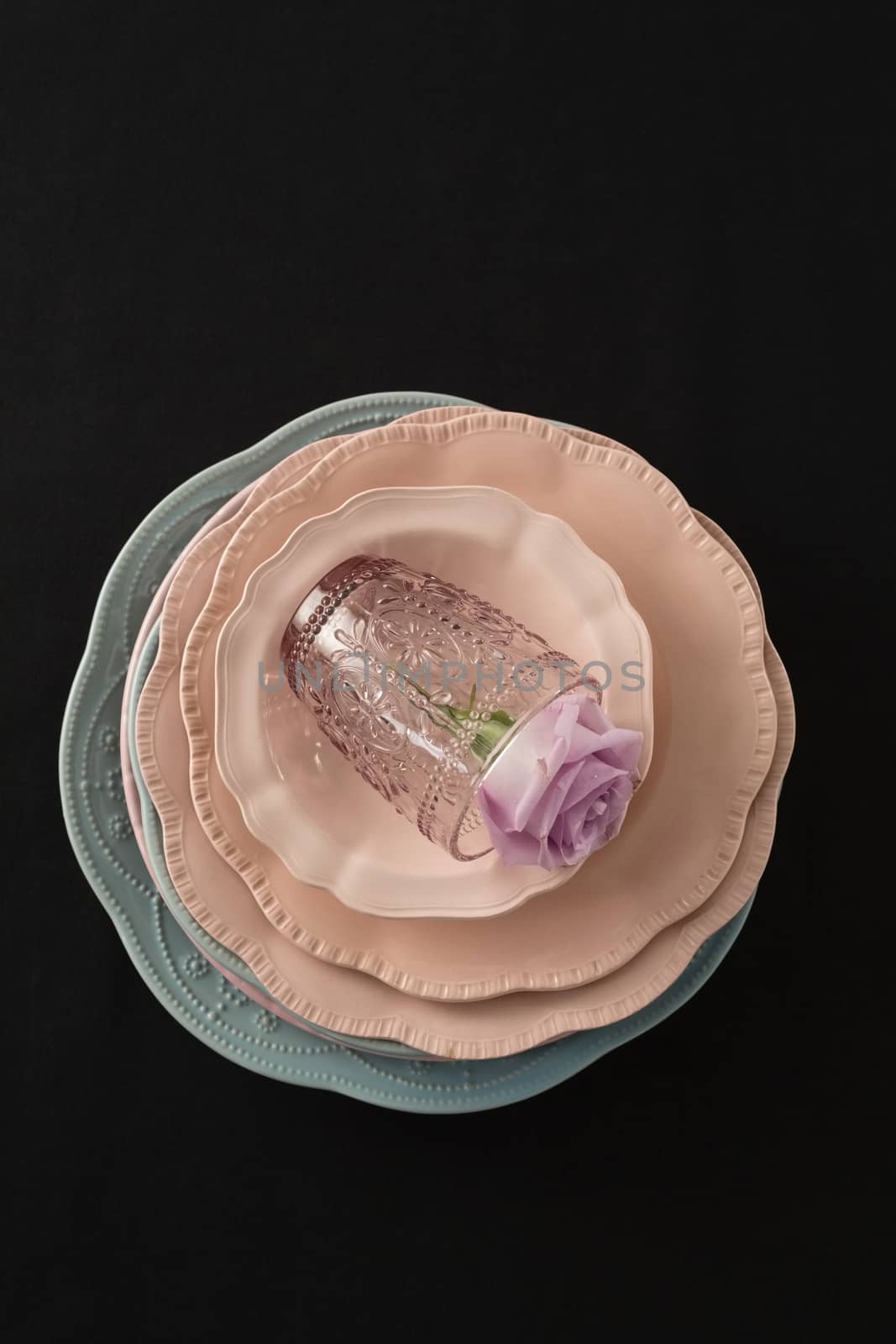 Overhead view of dining plates set on black theme table