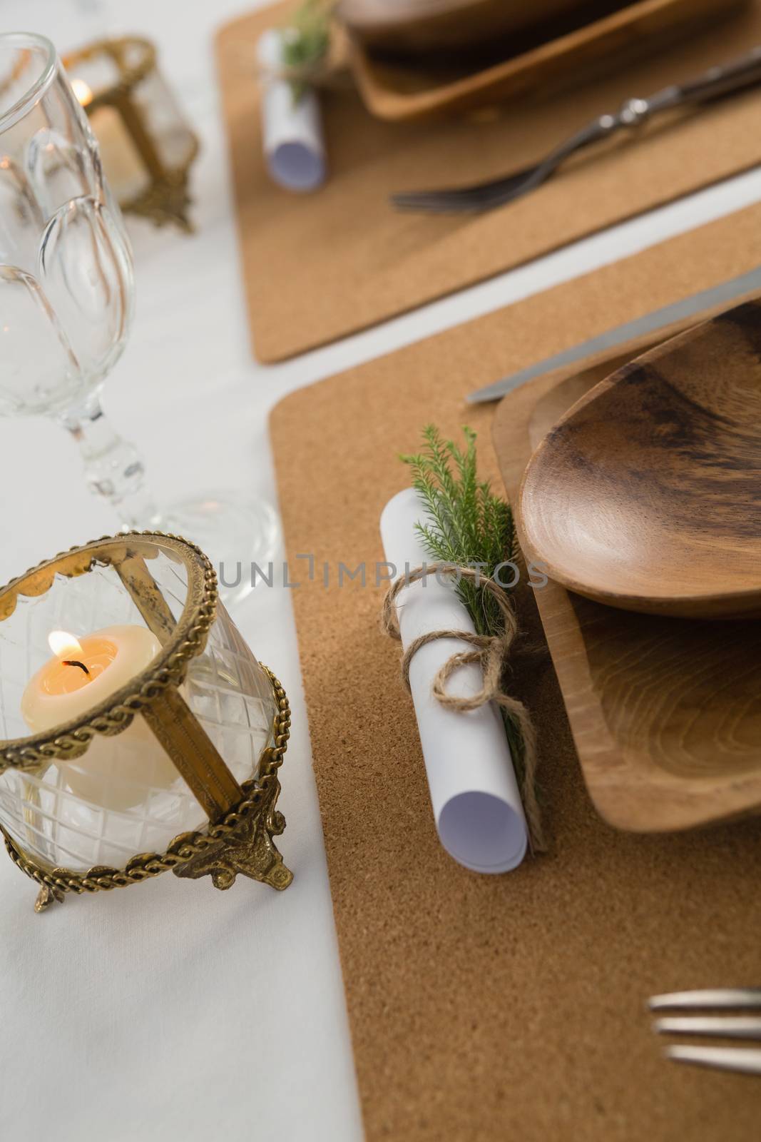 Close-up of wooden plate and cutlery set on a table