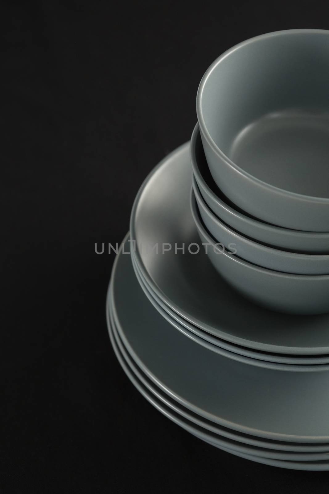Close-up of dining plates set on black theme table