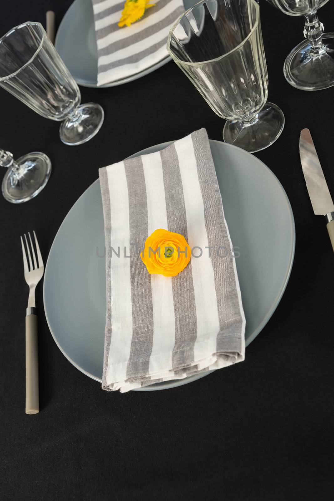 Close-up of beautiful table setting with floral arrangement 