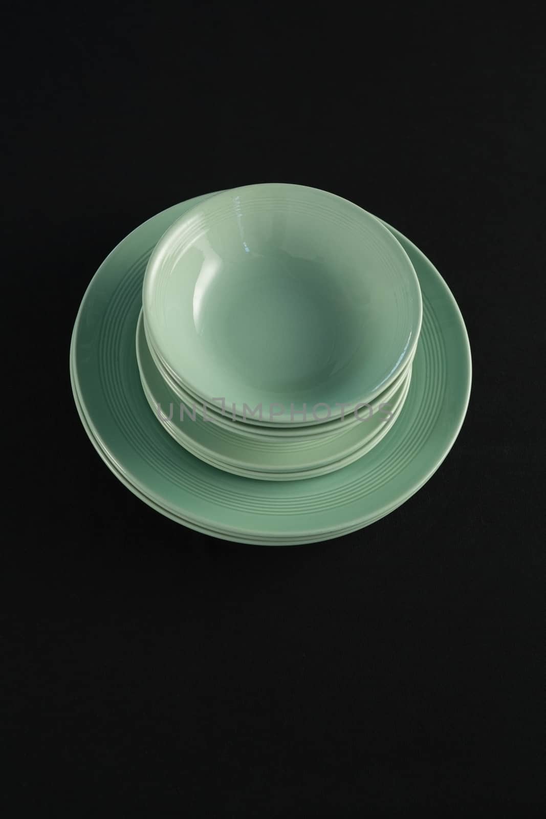 Overhead view of dining plates set on black theme table