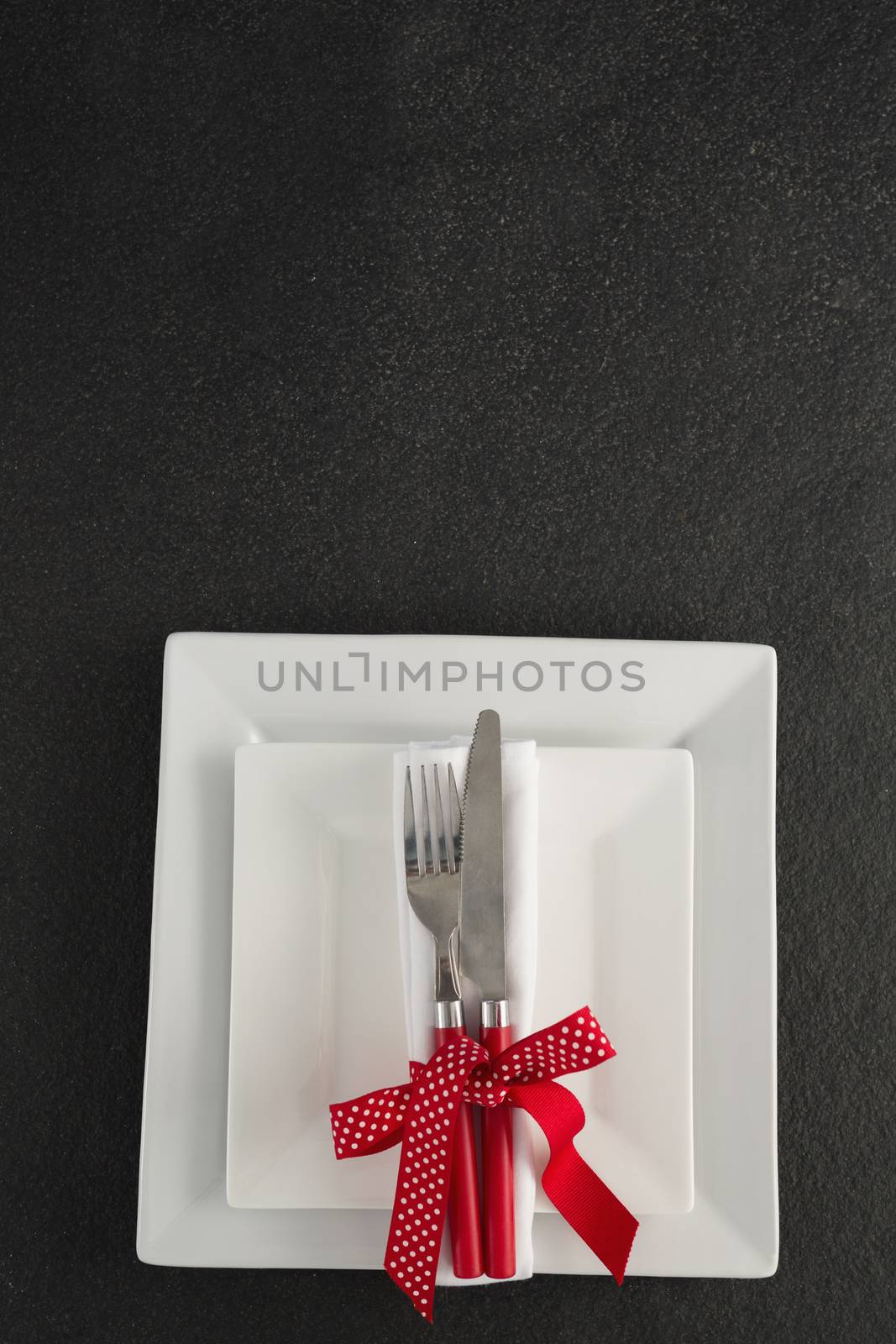 Close-up of table setting with square plates and cutlery