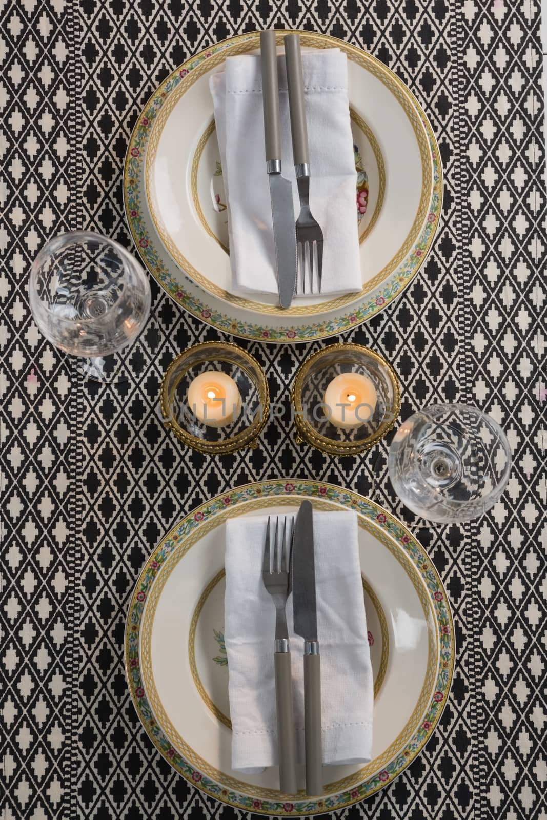 Overhead of elegance table setting with wine glasses on placemat