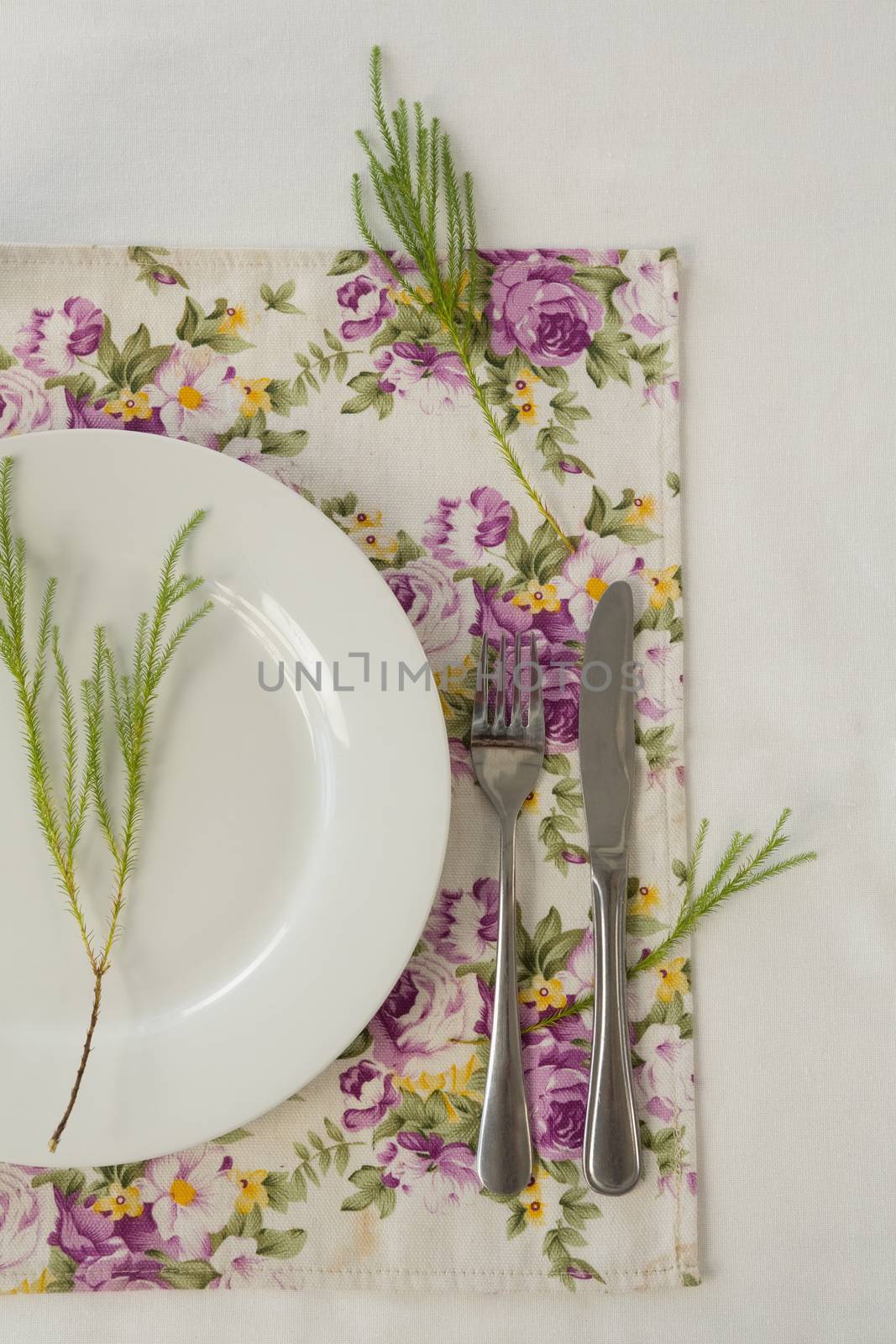 Overhead of elegance table setting on white background