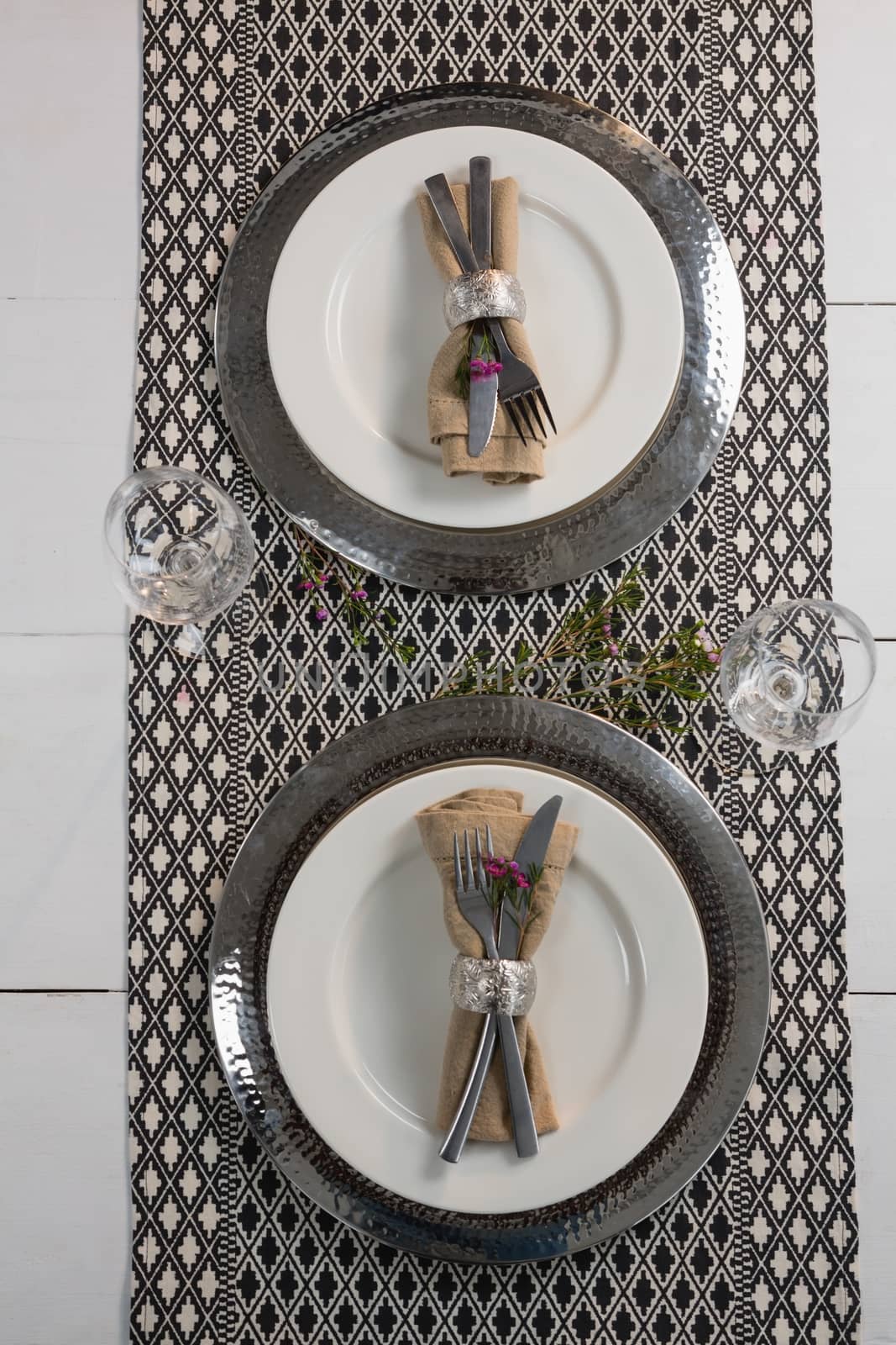 Overhead of elegance table setting with wine glasses on placemat