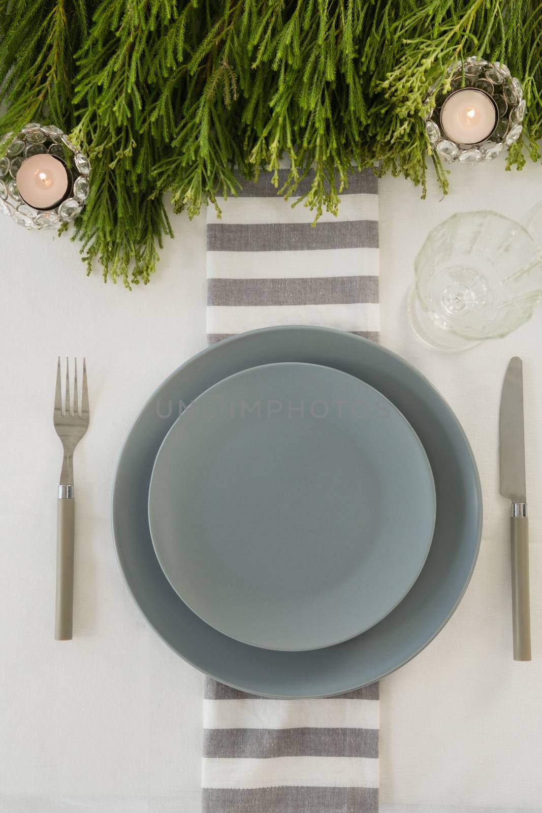 Overhead view of plate and cutlery set elegantly on a table