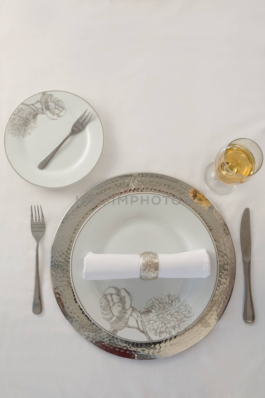 Overhead view of plate and cutlery set elegantly on a table