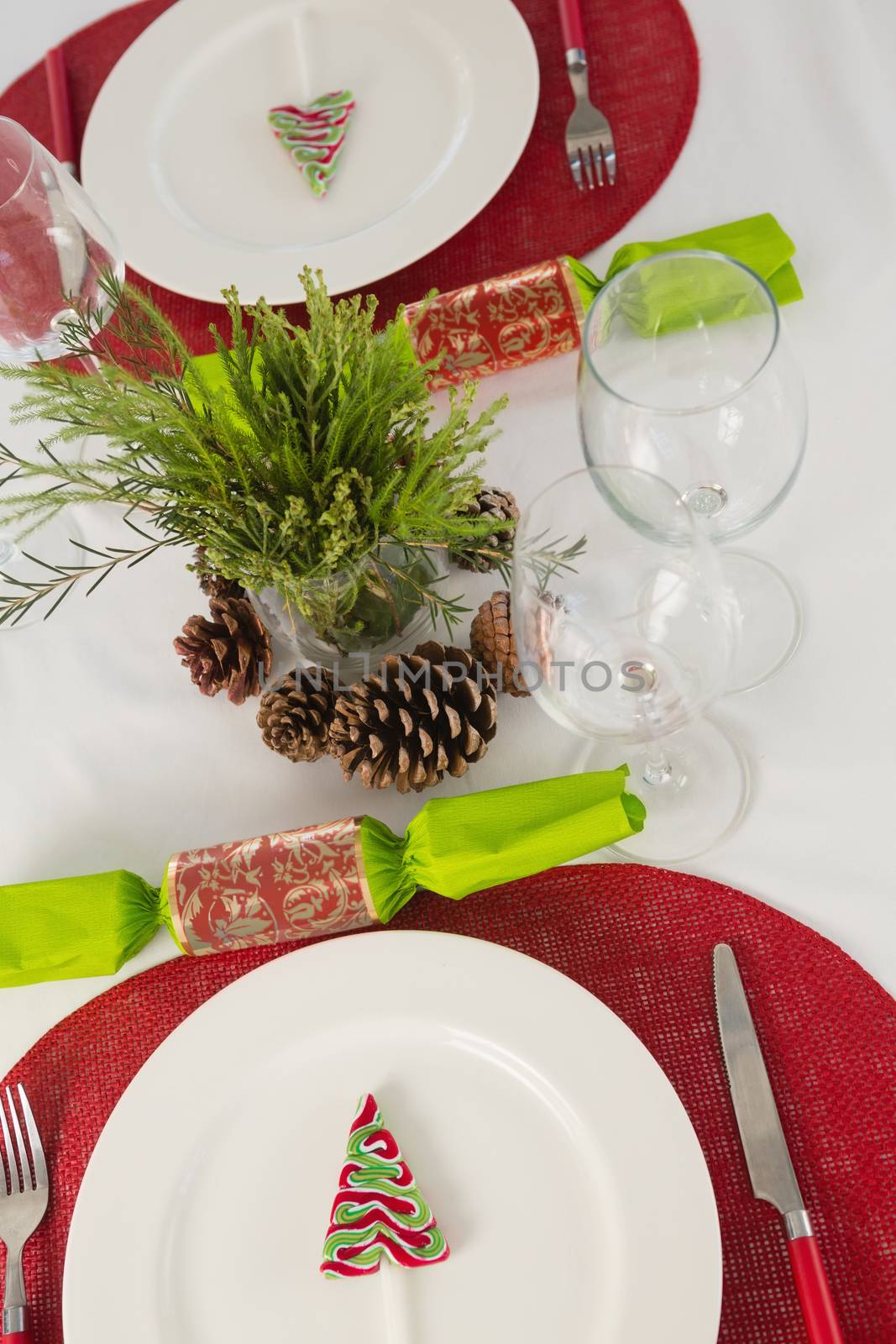 Overhead view of plate and cutlery set beautifully on Christmas theme