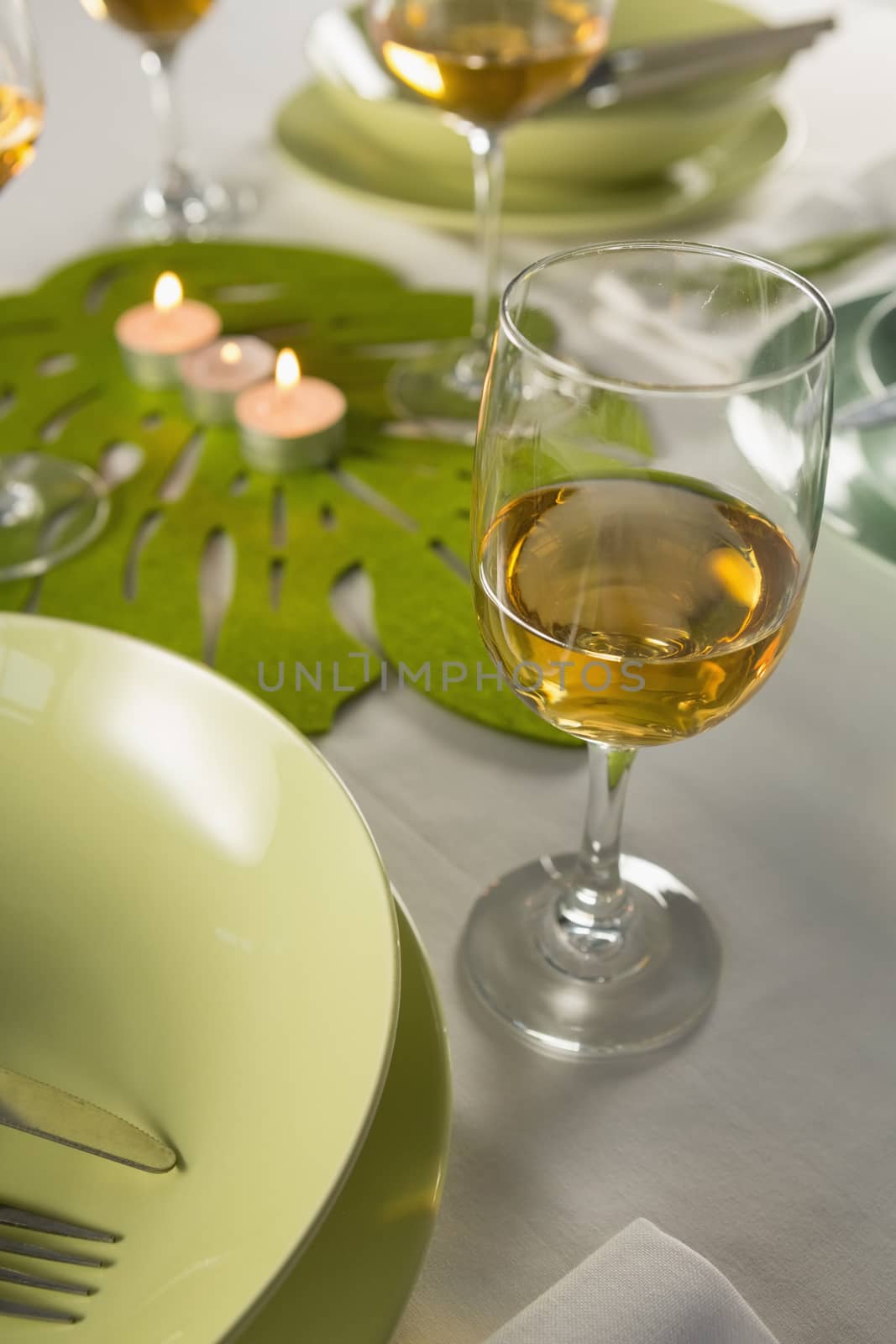 Close-up of wine glasses with table setting