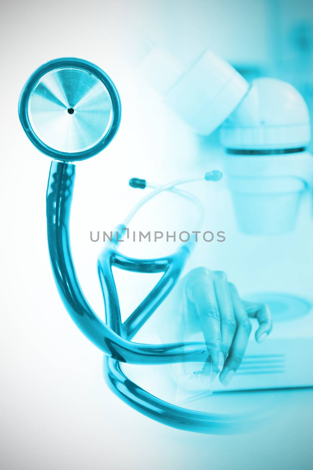 Blue stethoscope  against doctor holding microscope slide