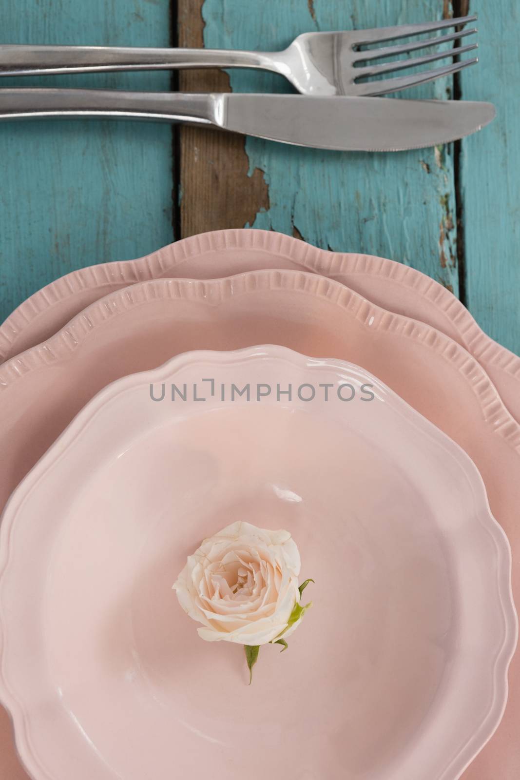 Close-up of table setting on wooden plank