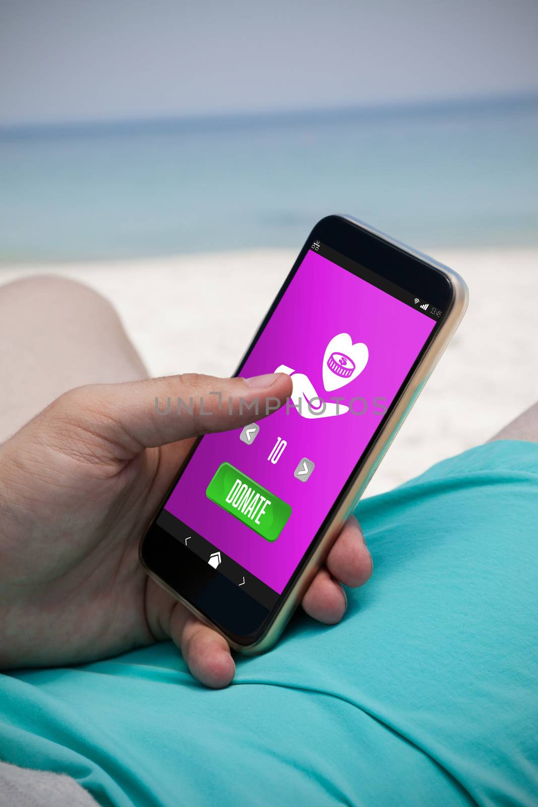 Vector icon of donation against close up of man using mobile phone at beach