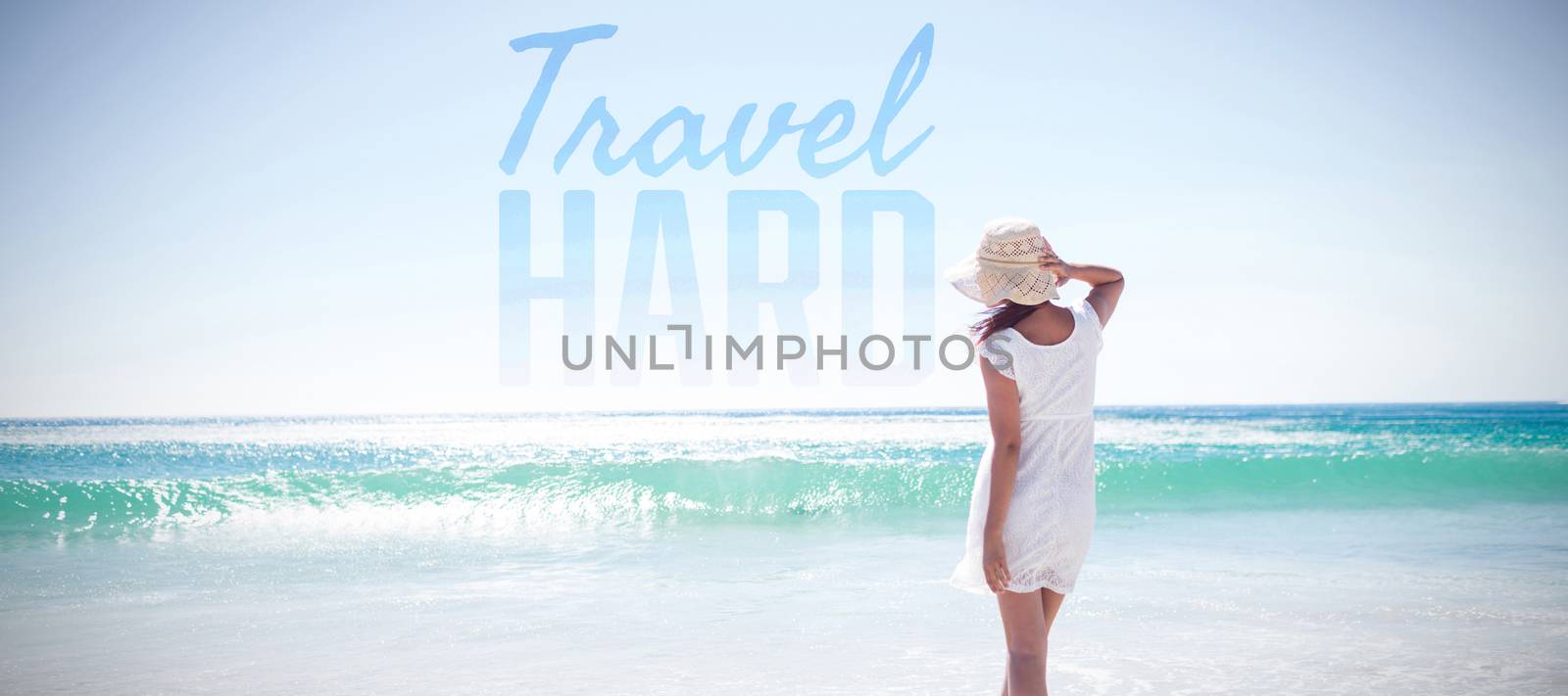 Travel hard against woman in straw hat at beach