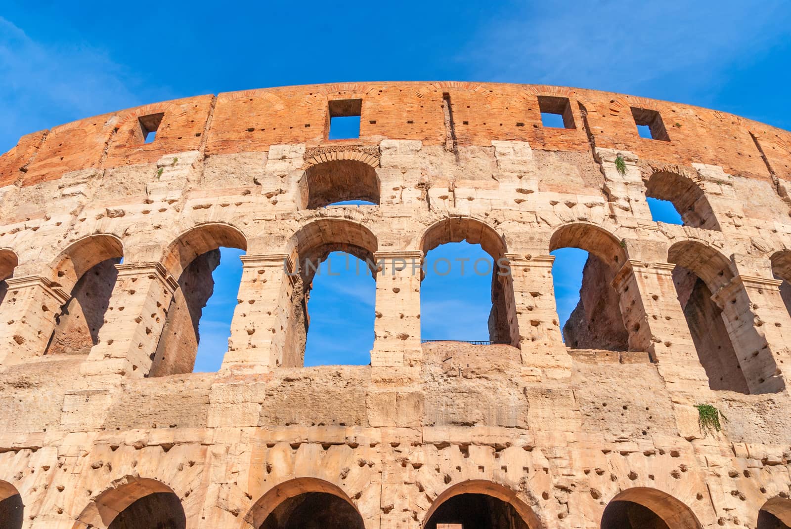 Colosseum in Rome, Italy. Ancient Roman Colosseum is one of the main tourist attractions in Europe. People visit the famous Colosseum in Roma center. Scenic nice view of Colosseum ruins in summer.