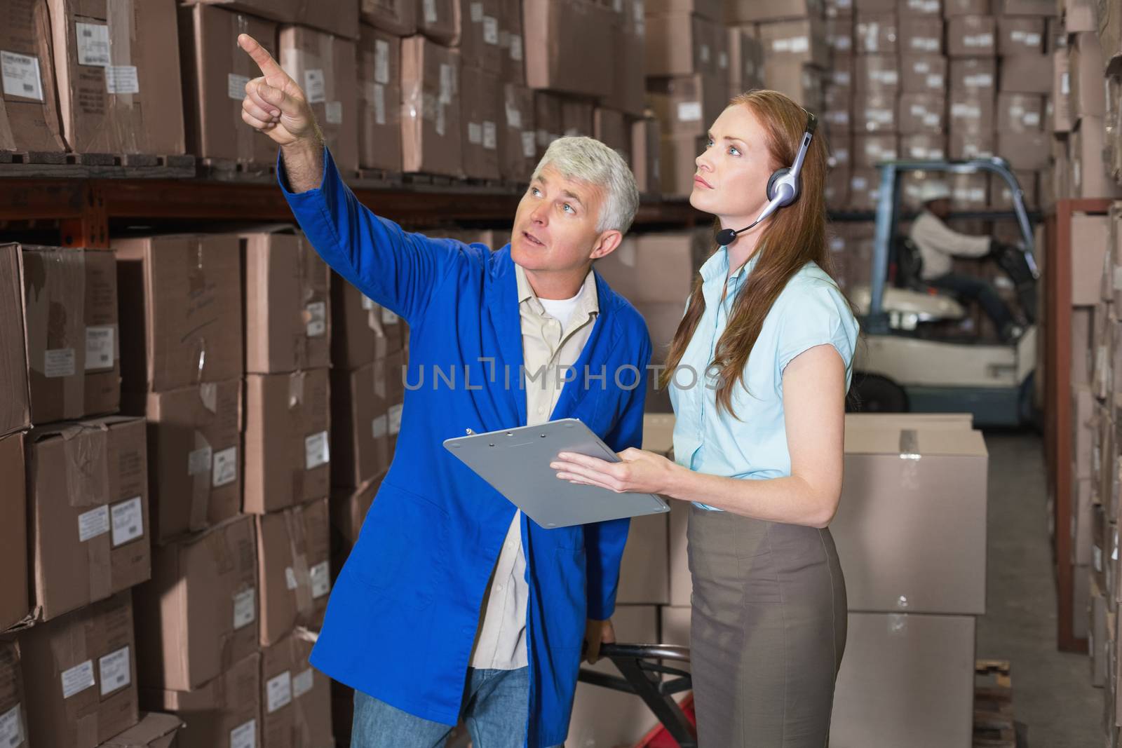 Warehouse manager and foreman working together by Wavebreakmedia