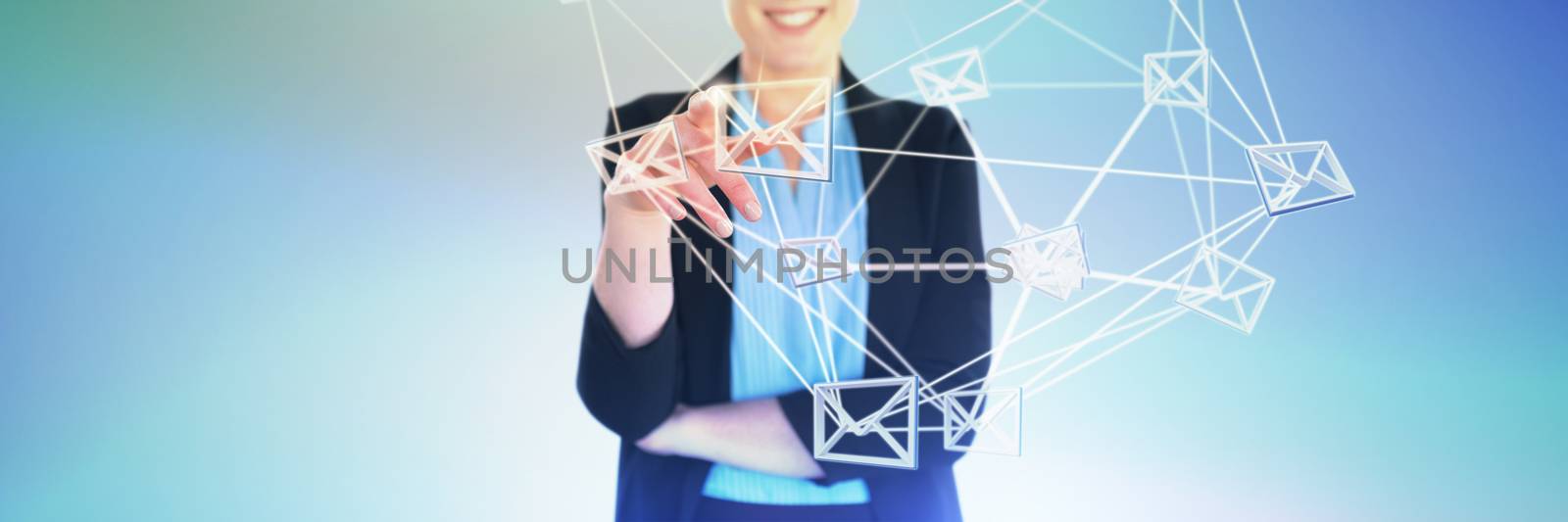 Mid section of smiling businesswoman pointing against abstract blue background