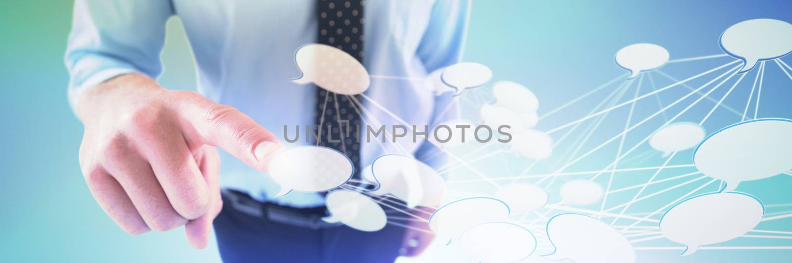 High angle view of businessman using imaginary screen against abstract grey background