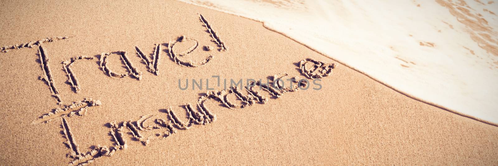 Travel Insurance text written on sand by Wavebreakmedia
