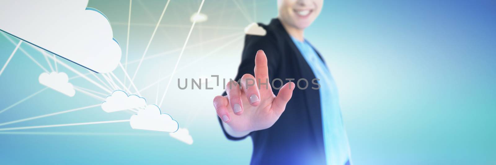 Mid section of smiling businesswoman touching imaginary interface against abstract green background,