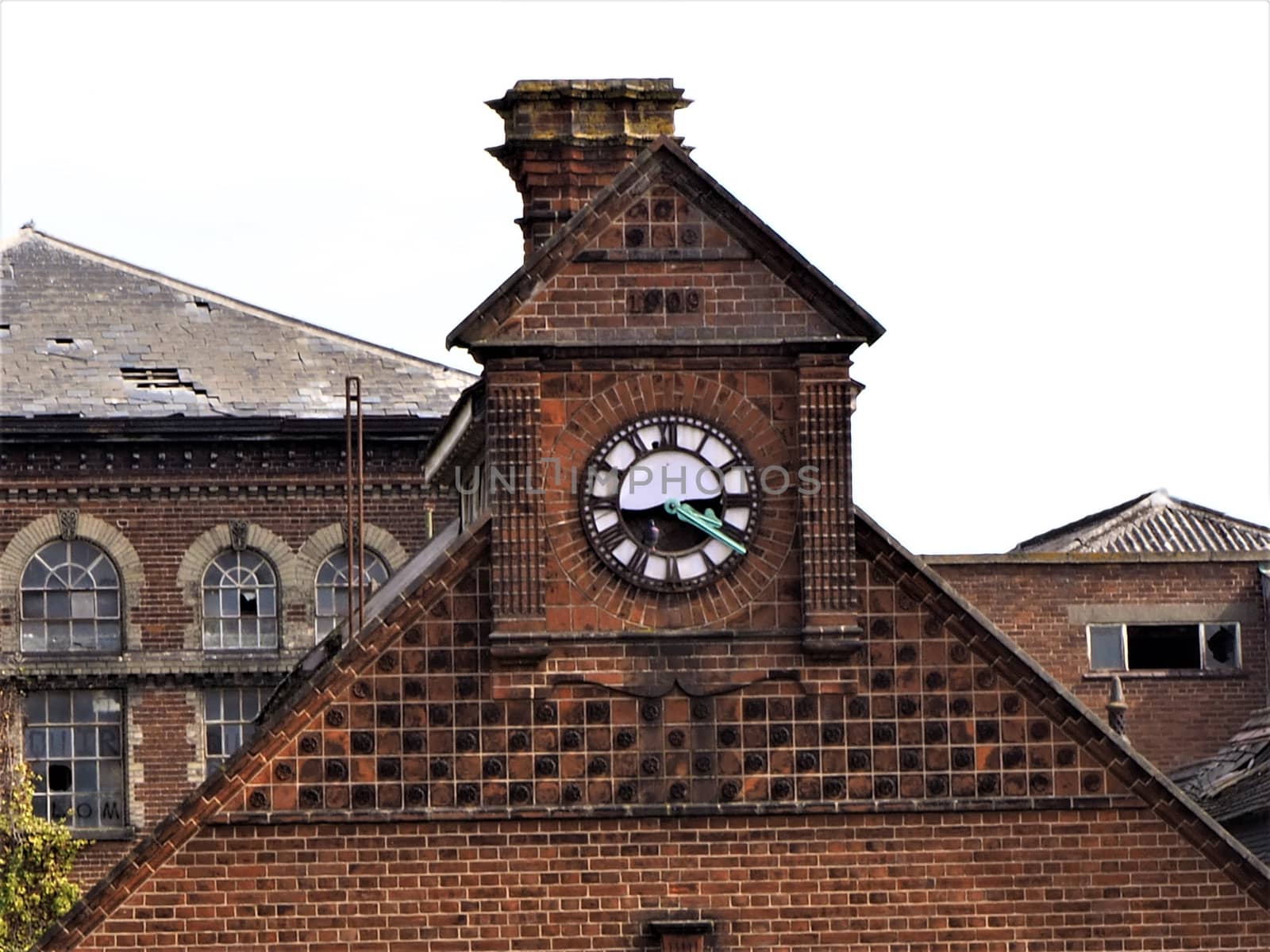 Old factory in Norwich, Norfolk, UK. Derelic and unsued for years, with a brocken clock. Victorian industrial revolution era industry.