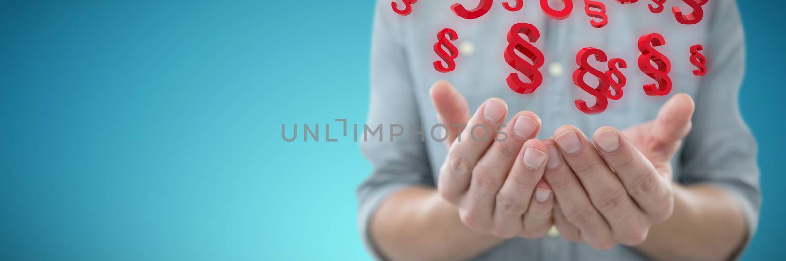 Cupped hands of man holding invisible object against abstract blue background