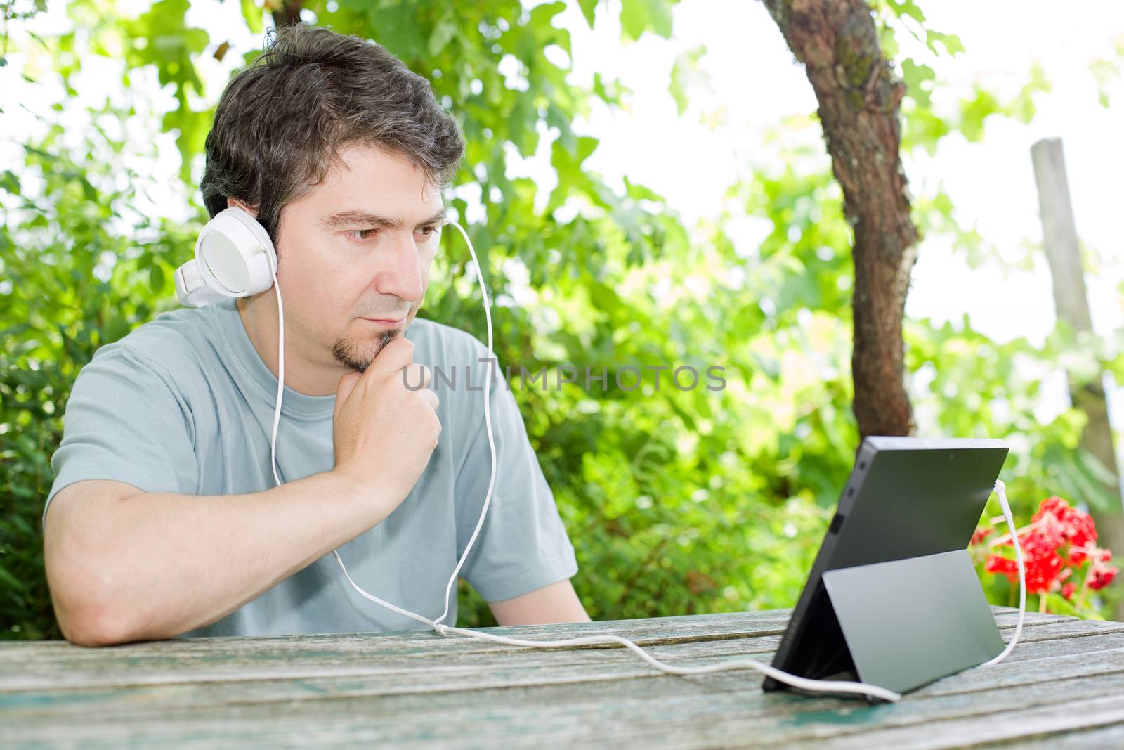 casual man working with a tablet pc, outdoor