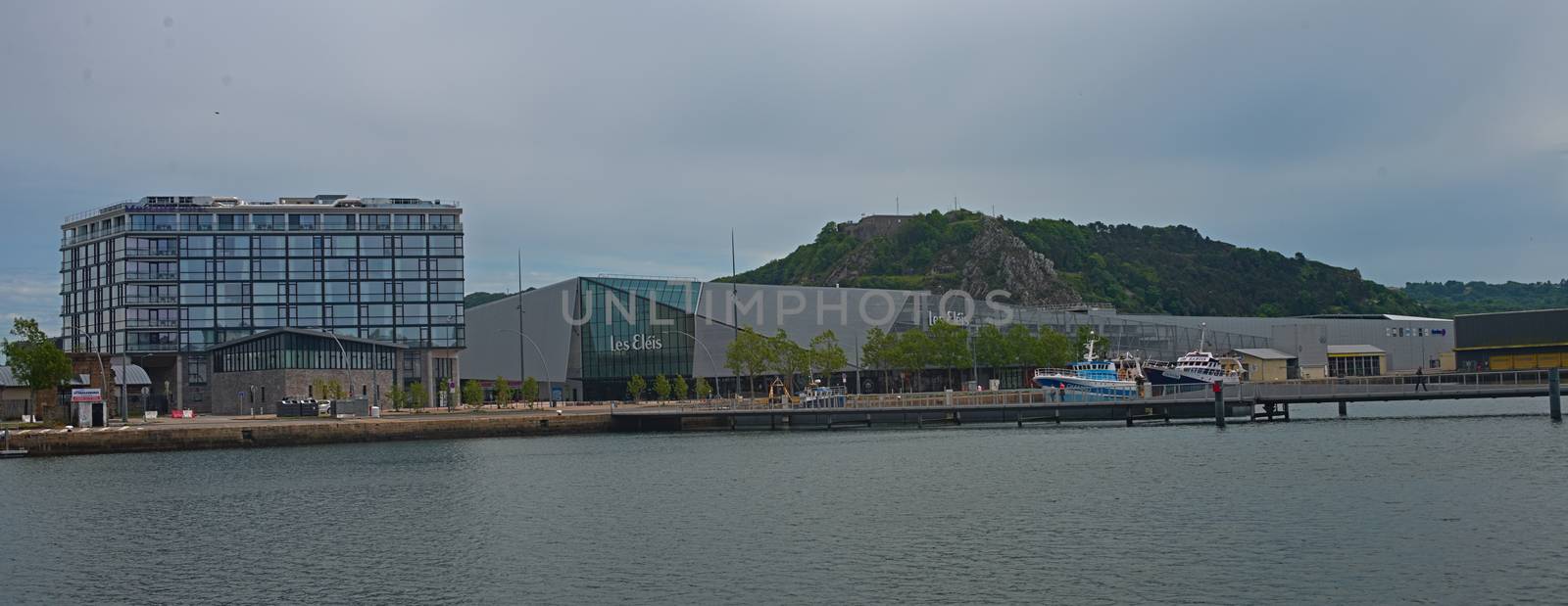 CHERBOURG, FRANCE - June 6th 2019 - Pier with dock and modern building at shore by sheriffkule