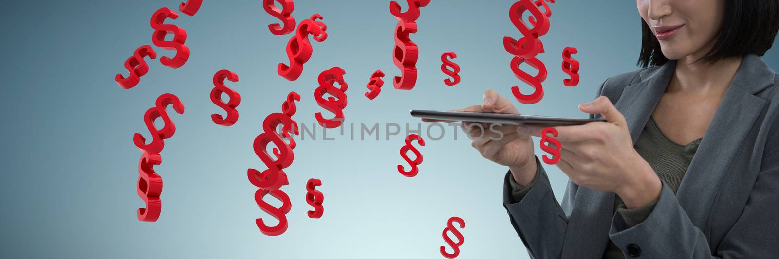 Businesswoman using digital tablet against abstract grey background
