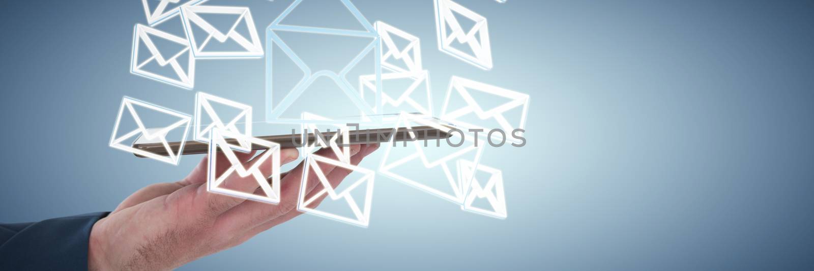 Cropped hand of businessman holding tablet computer against abstract blue background