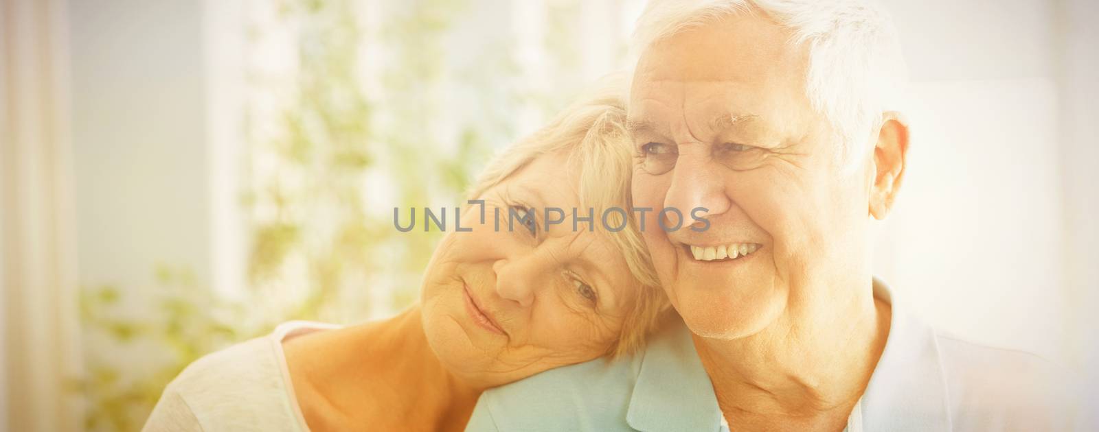 Happy romantic senior couple smiling at home