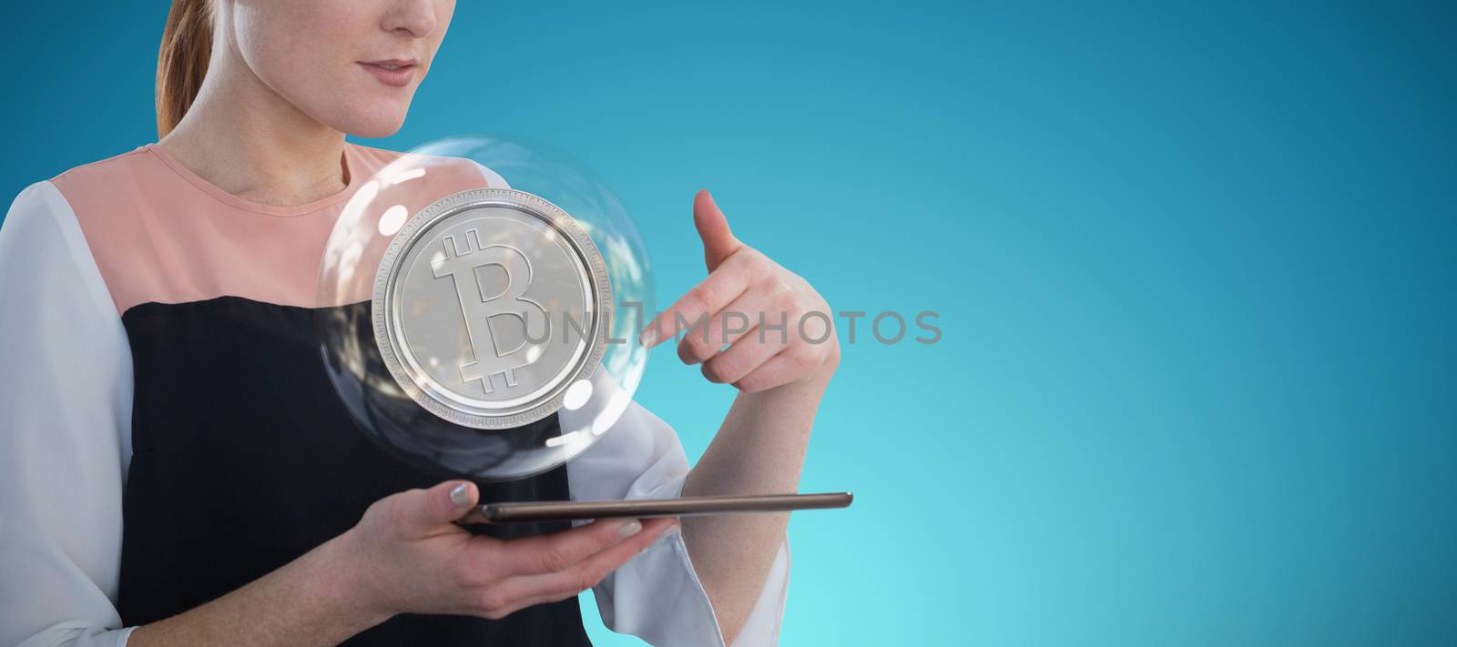 Businesswoman holding tablet computer against abstract blue background