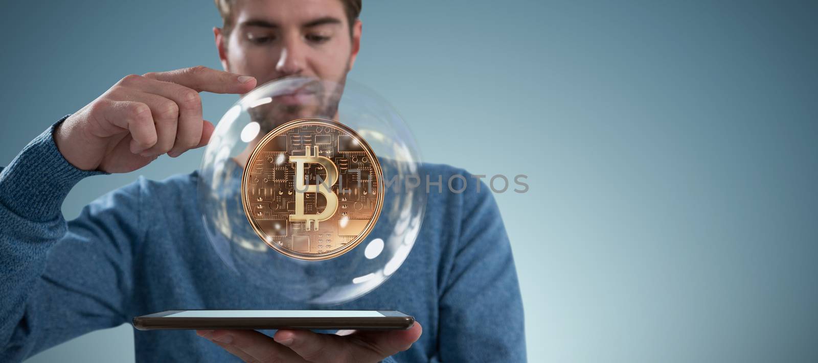 Man holding digital tablet against abstract grey background