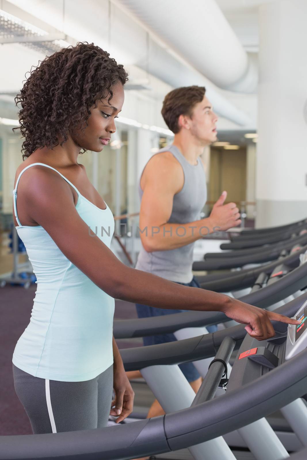 Fit people running on treadmills by Wavebreakmedia