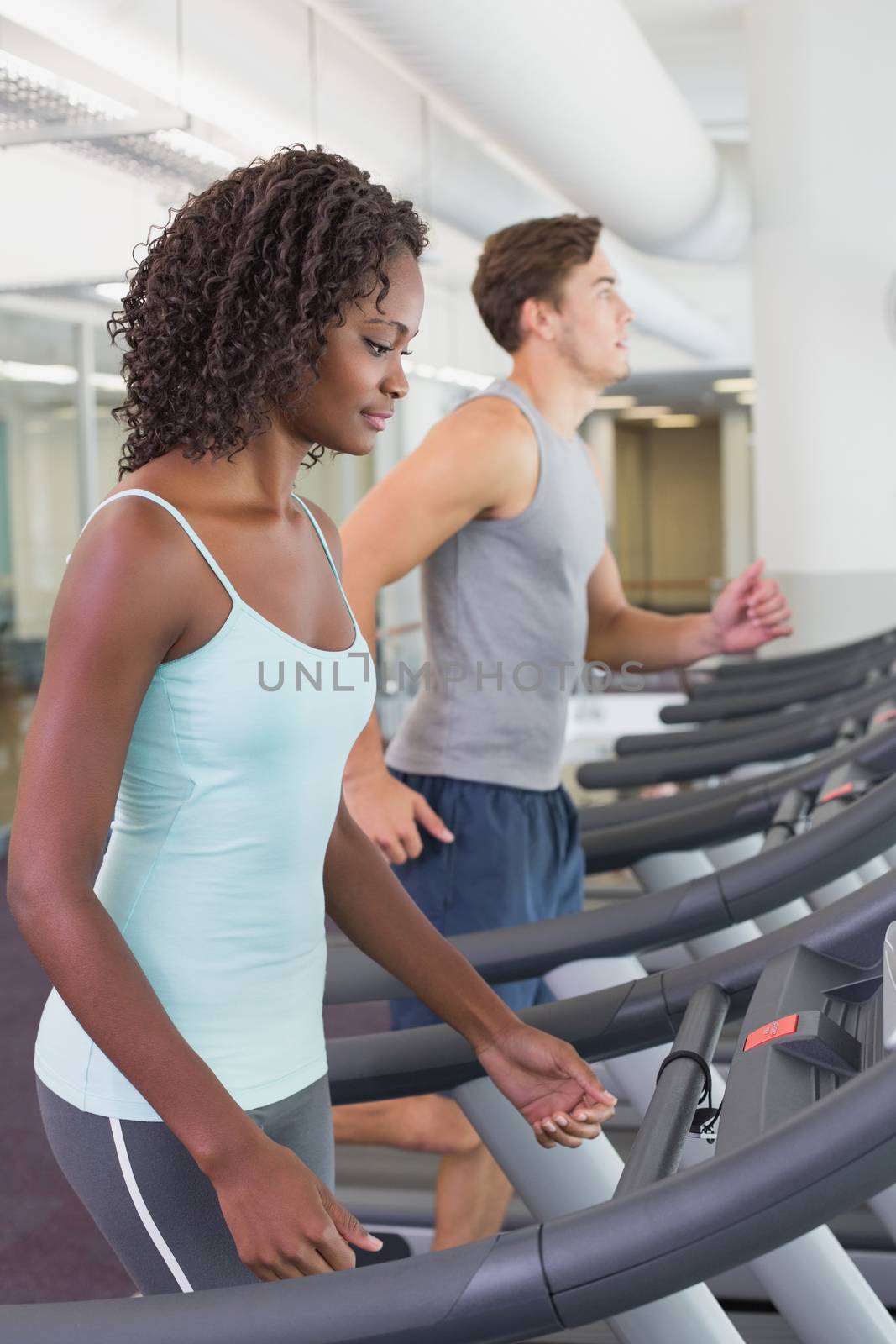 Fit people running on treadmills by Wavebreakmedia