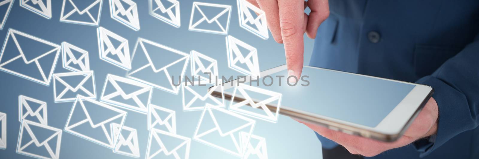 Close up mid sectiong of businessman using tablet PC against abstract blue background