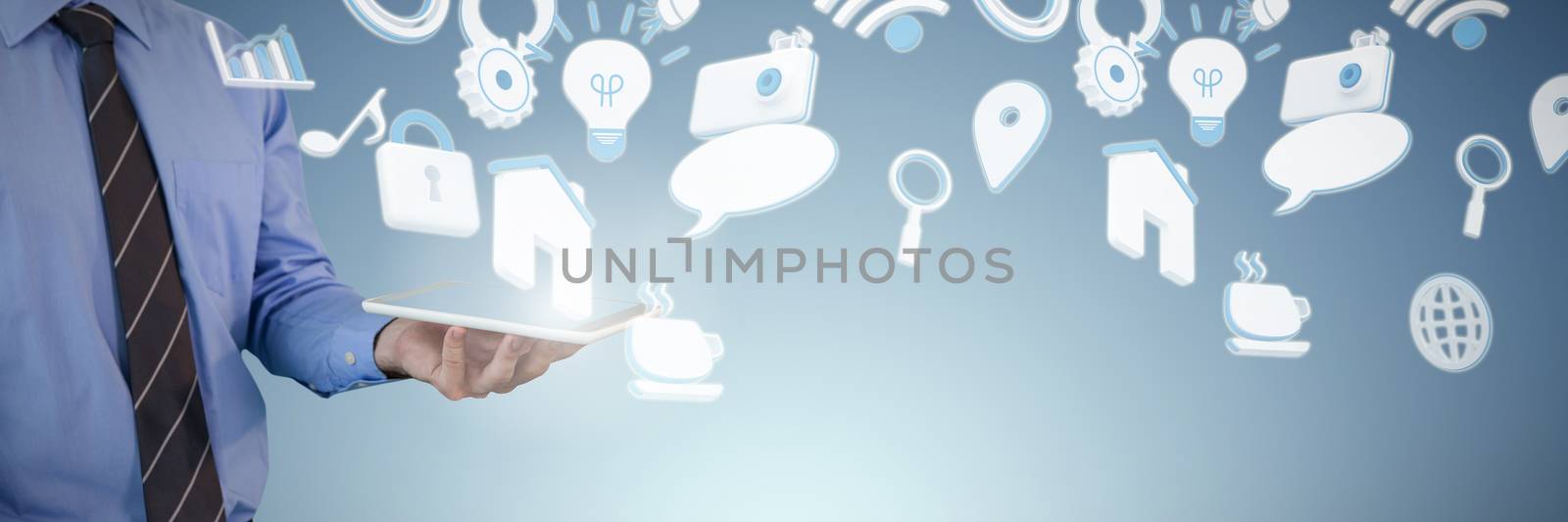 Mid section of businessman holding tablet PC against abstract blue background