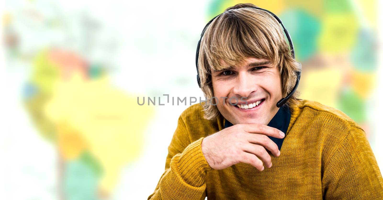 Travel agent man wearing headset in front of world map by Wavebreakmedia