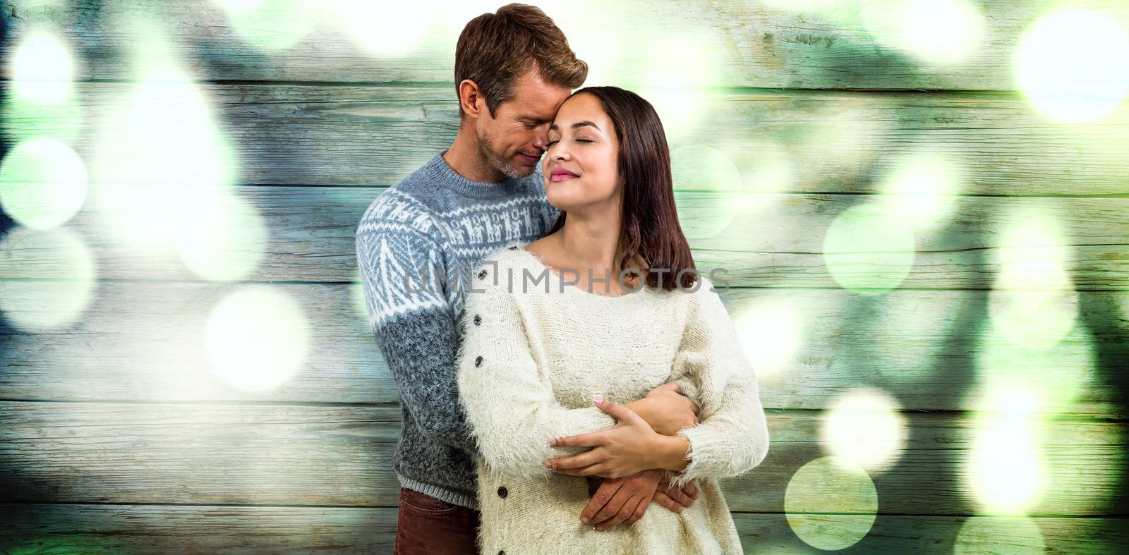 Romantic couple in warm clothing against background full of blurred light
