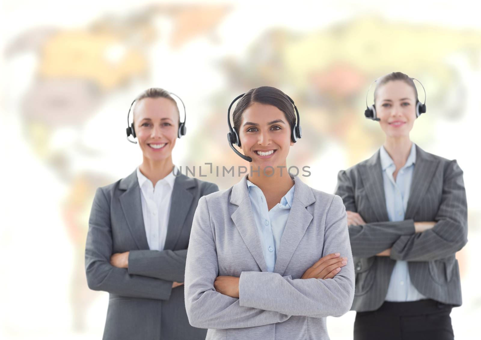 Travel agents wearing headset in front of world map by Wavebreakmedia