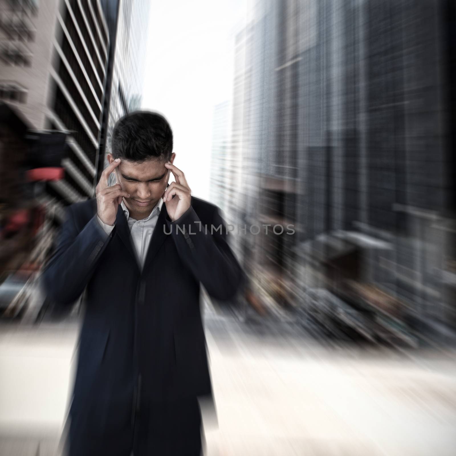 Composite image of businessman with head in hand suffering from headache by Wavebreakmedia