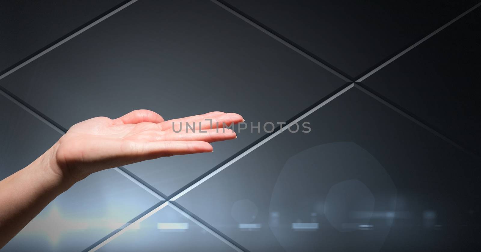 Hand open with grey technology background by Wavebreakmedia