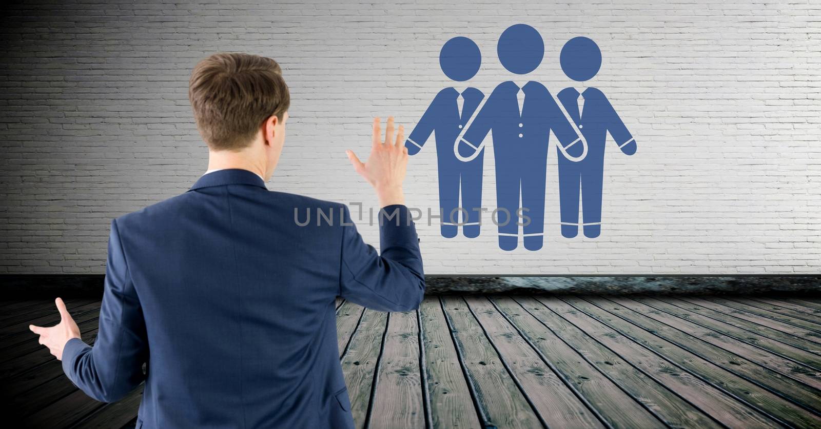 Digital composite of Business people group on wall with businessman
