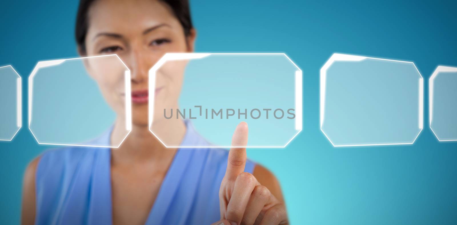 Close up of smiling businesswoman touching interface against abstract blue background