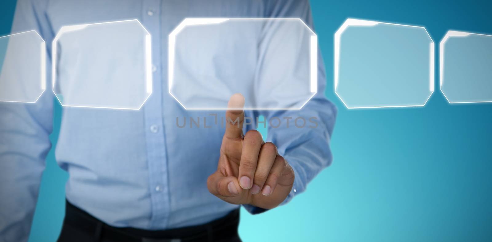Mid section of businessman touching invisible screen against abstract blue background