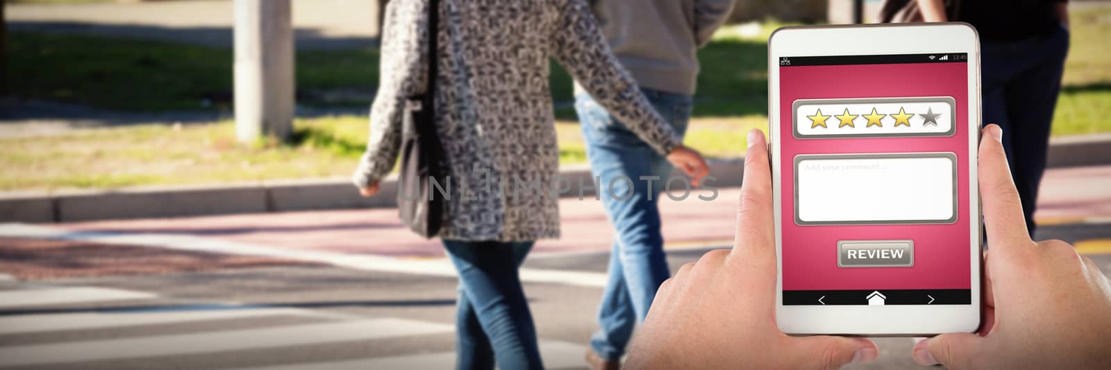 Cropped hands on businessman with digital tablet against low section of people crossing road