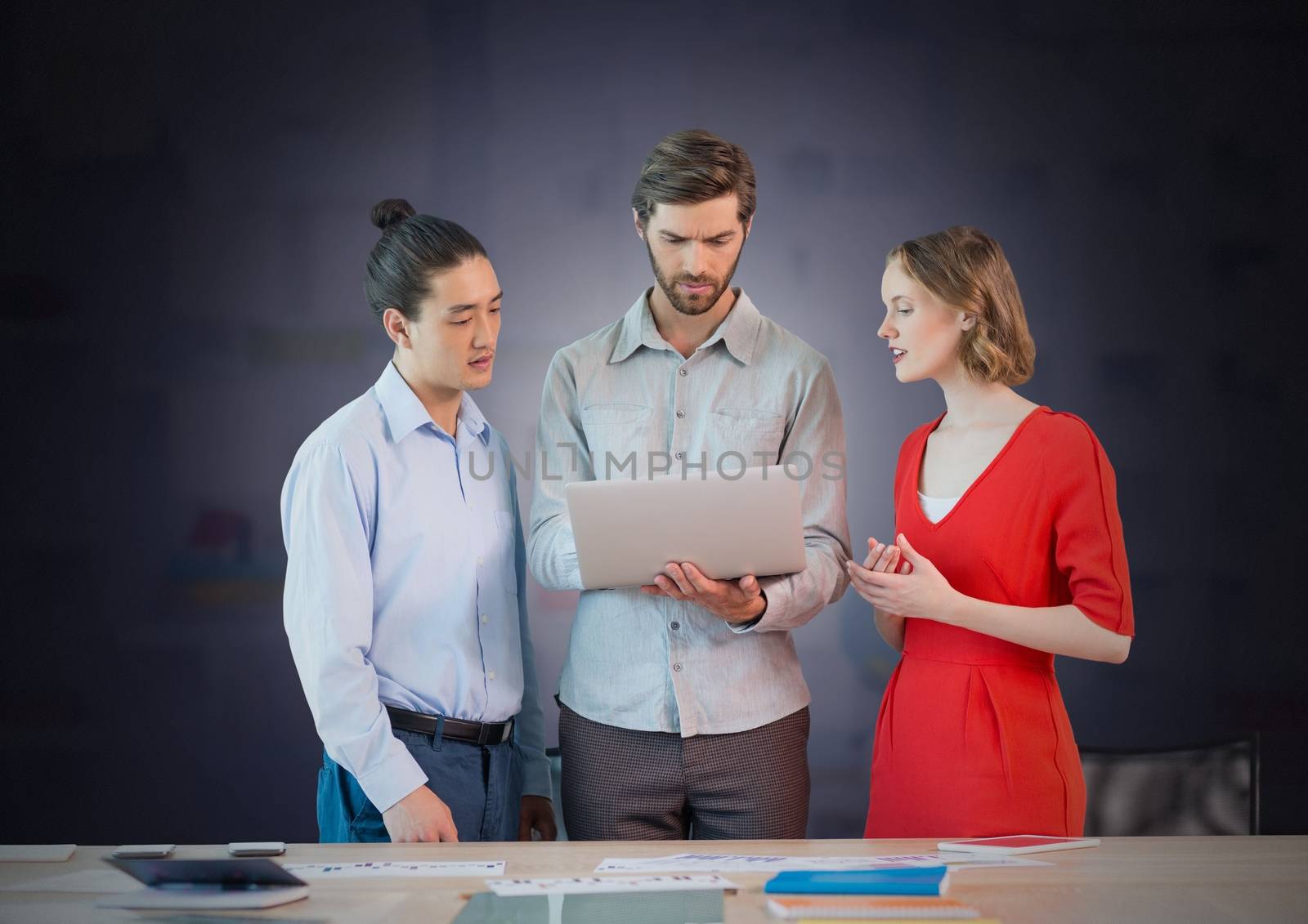 Digital composite of Business people working on laptop