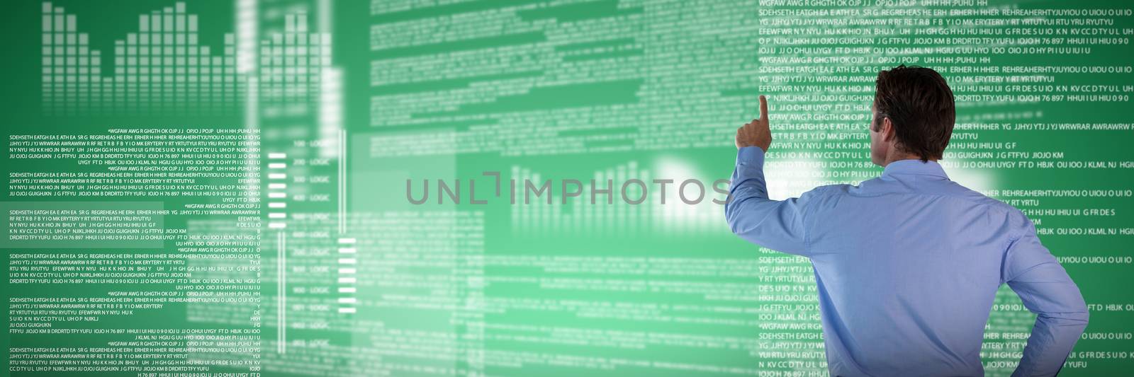 Rear view of businessman with hand on hip touching invisible interface against abstract green background
