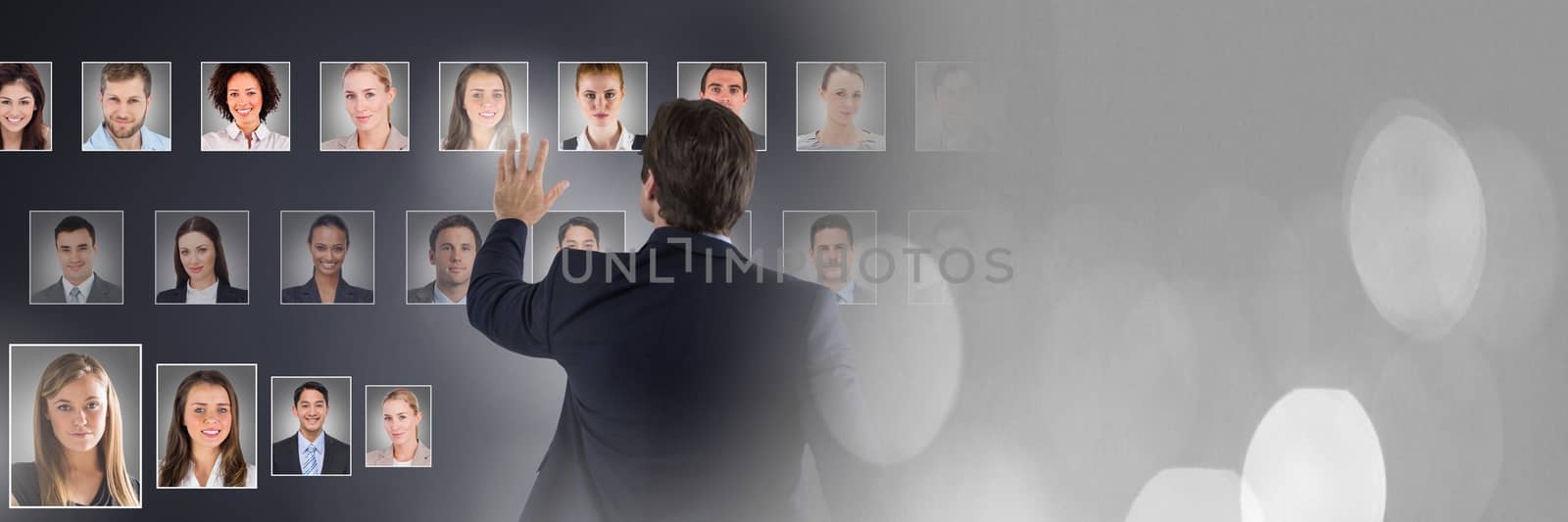 Man touching portrait profiles of different people by Wavebreakmedia
